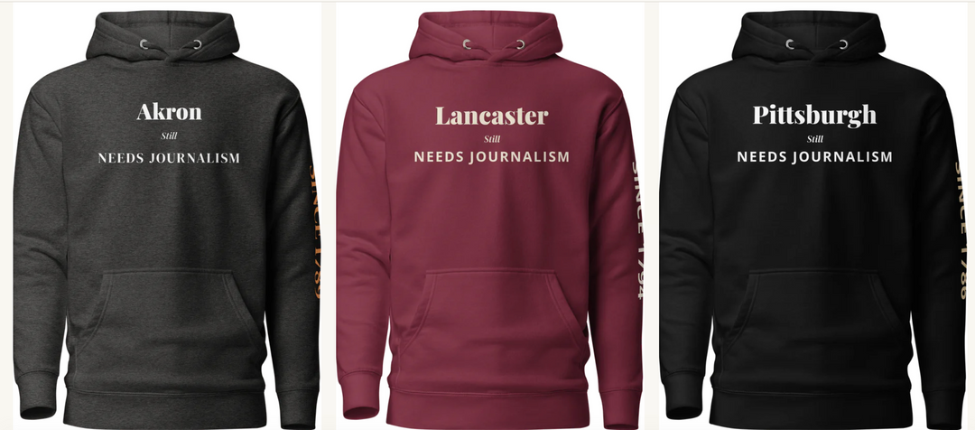 Three hoodies from the Editorial Style "Press Was Here First" collection, reading Akron, Lancaster, and Pittsburgh, each printed with "Still Needs Journalism" and a newspaper founding date on the sleeve.