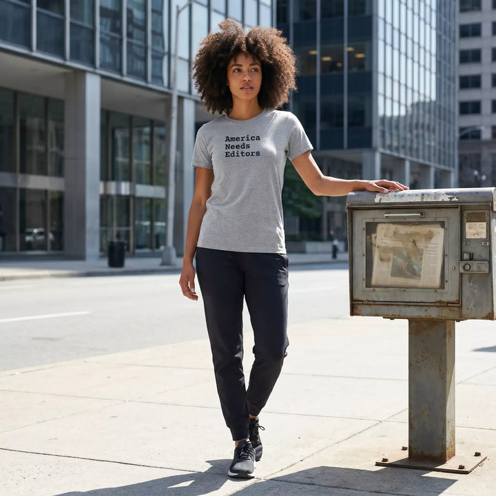 Woman wearing a gray t-shirt that says &
