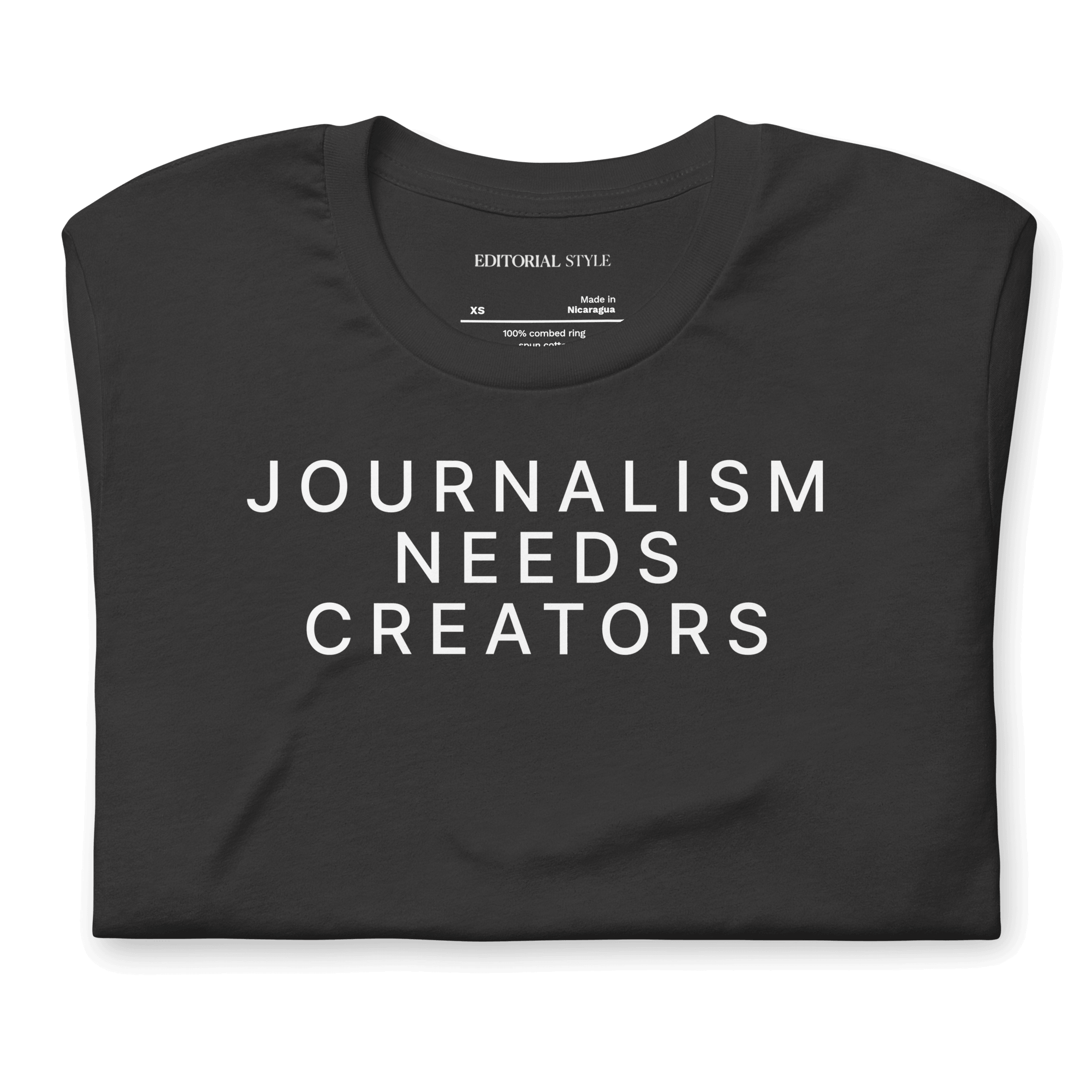 Creator statement tee showcasing the text 'JOURNALISM NEEDS CREATORS' on a black background.